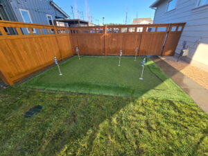 Putting green surrounded by fence